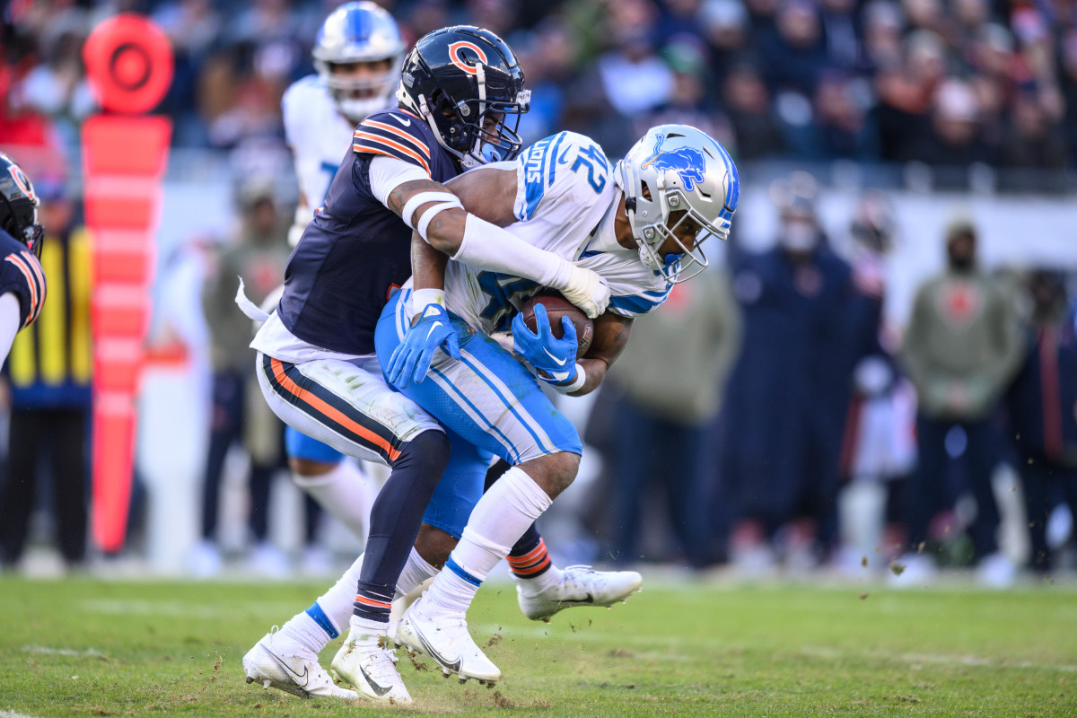 Chicago Bears strong safety Jaquan Brisker tackles Detroit Lions running back Justin Jackson